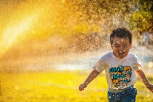 Happy child playing outdoors in the sunshine